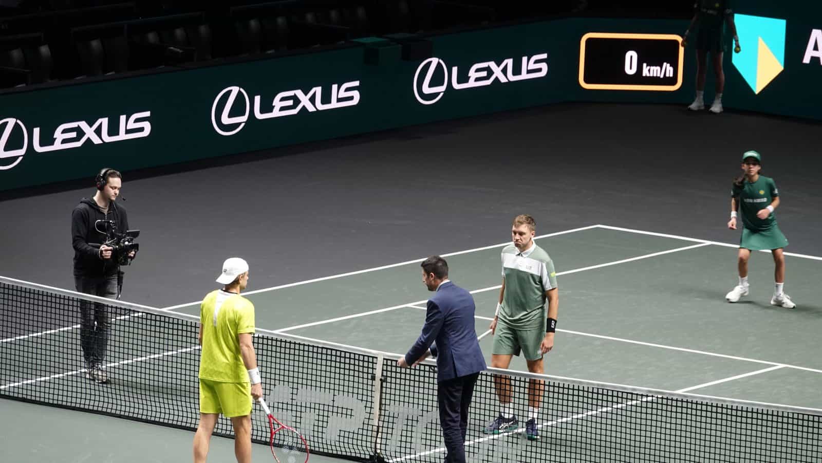 Hamad Medjedovic and Zizou Bergs at the net with the chair umpire during their match at the Rotterdam ATP 500