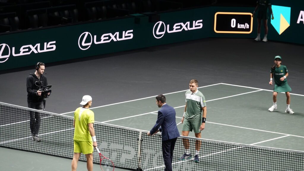 Hamad Medjedovic and Zizou Bergs at the net with the chair umpire during their match at the Rotterdam ATP 500