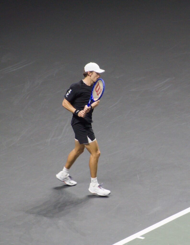 Alex de Minaur hits a backhand during his first-round match against Arthur Fils at the Rotterdam ATP 500 2026