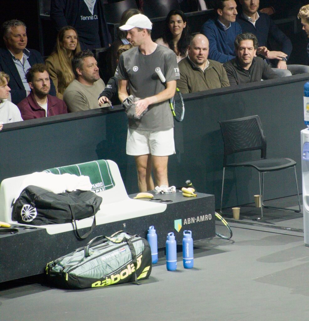 Botic van de Zandschulp consults with his team during his match against Stefanos Tsitsipas at Rotterdam 2026.