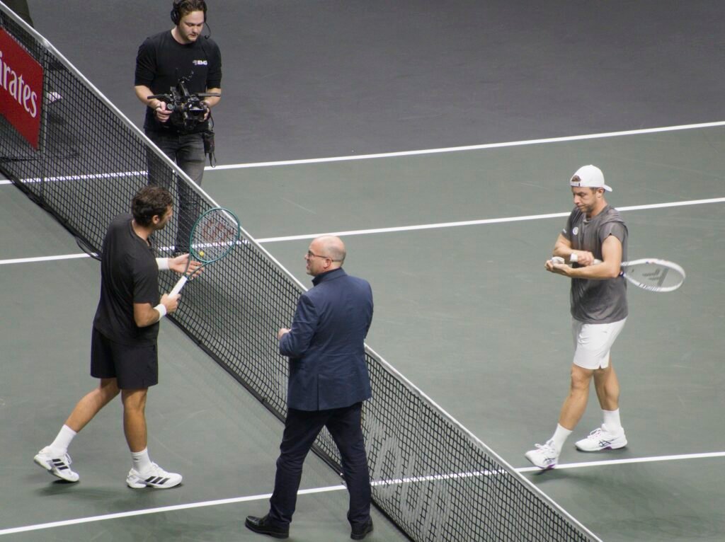 The umpire tosses a coin with Tallon Griekspoor and Quentin Halys before their match at Rotterdam 2026.