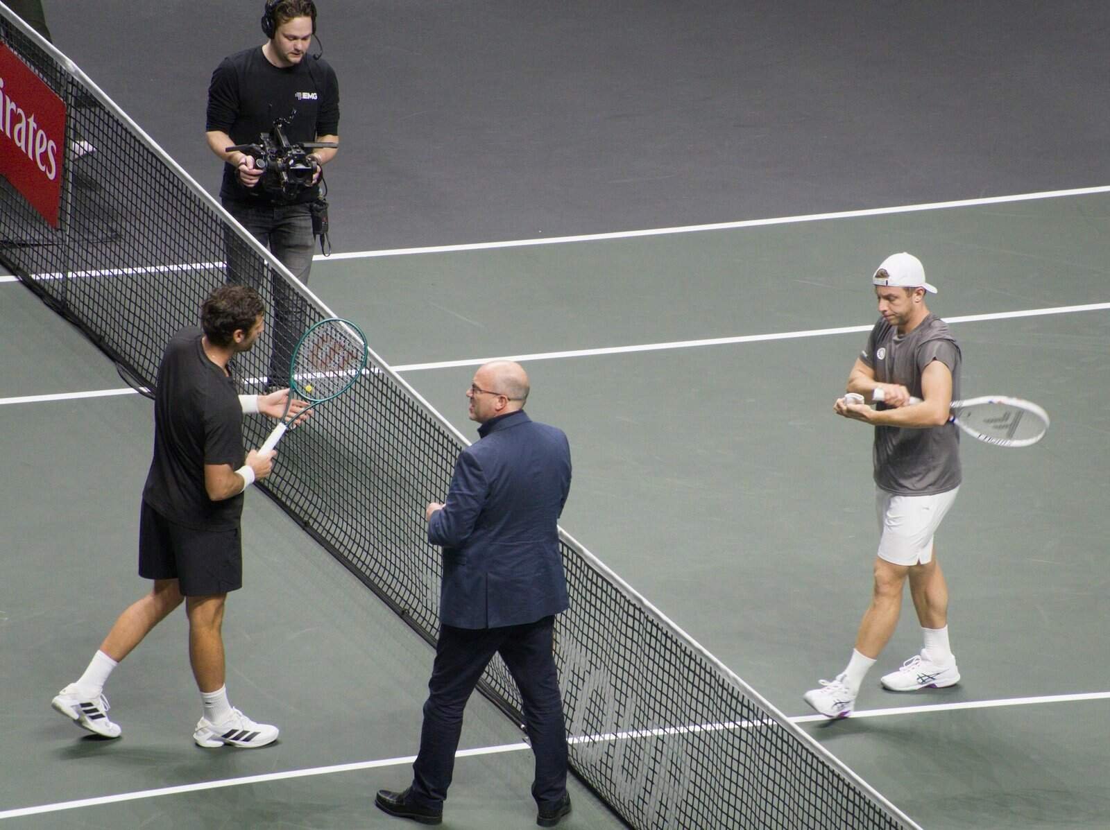 The umpire tosses a coin with Tallon Griekspoor and Quentin Halys before their match at Rotterdam 2026.