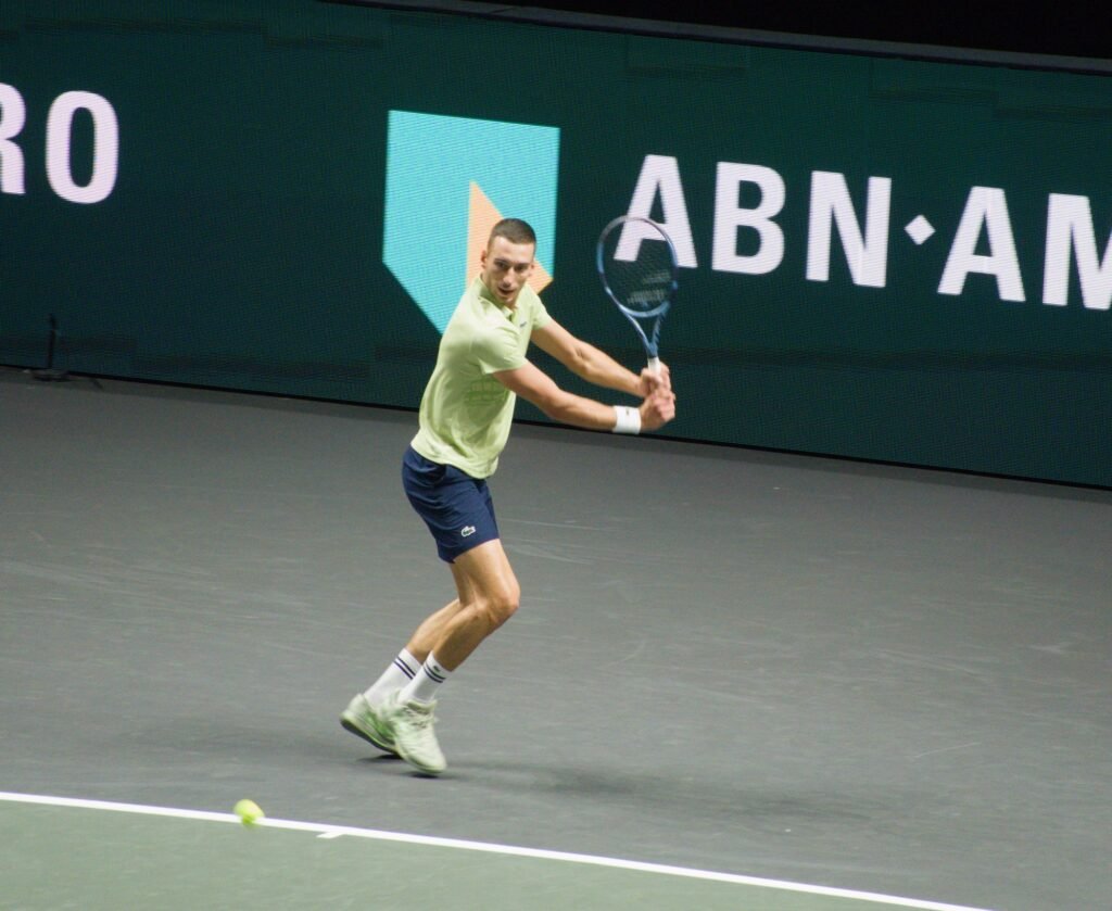 Luka Pavlovic hits a backhand during his first-round match against Botic van de Zandschulp at the Rotterdam ATP 500 2026