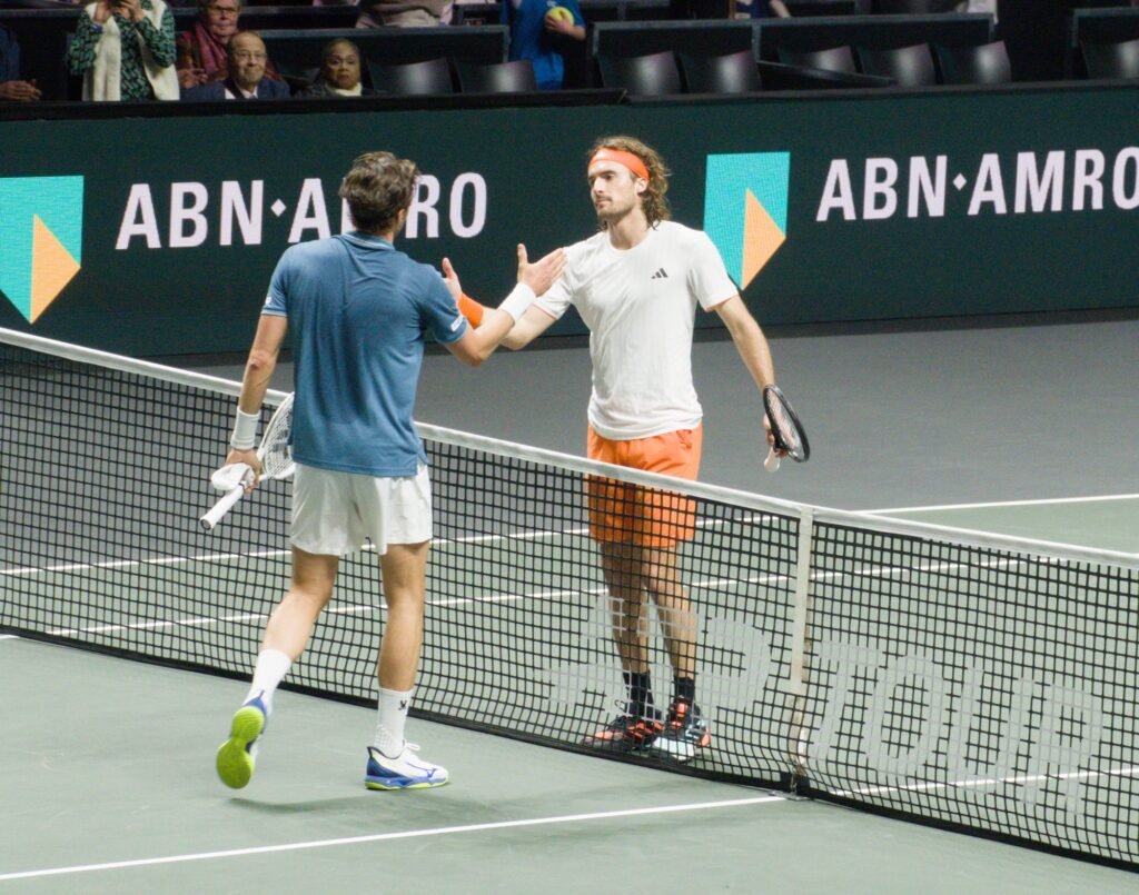 Stefanos Tsitsipas and Arthur Rinderknech shake hands after their first-round match at the Rotterdam ATP 500 2026