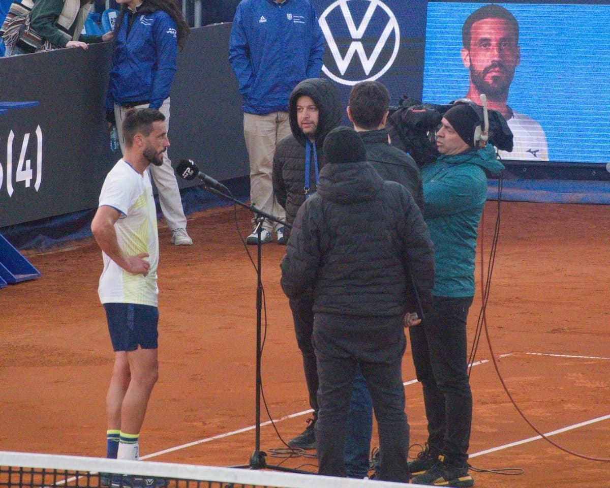 Tennis player Damir Dzumhur being interviewed on court after his victory in Bucharest