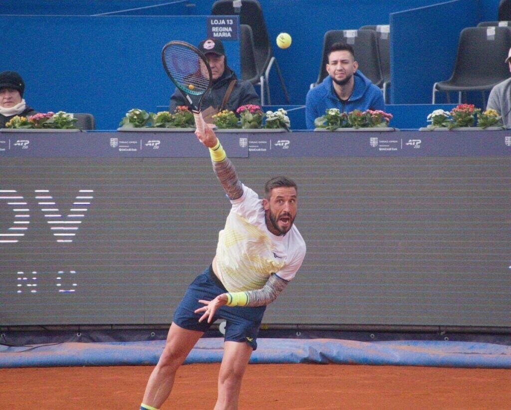 Professional tennis player Damir Dzumhur performing a powerful serve at the Bucharest Open