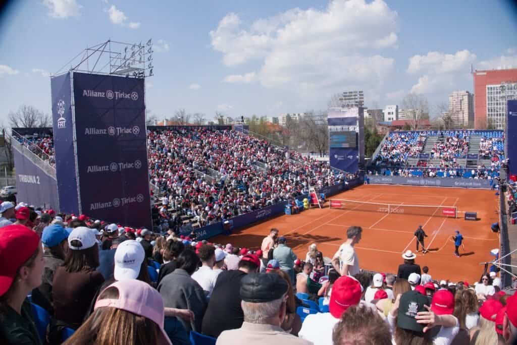 A wide shot of the packed stands and the red clay court at the Tiriac Open 2026 in Bucharest