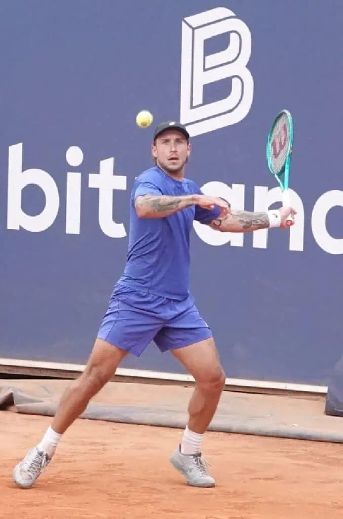 Slovak tennis player Alex Molcan hitting a forehand during his victory over Sebastian Ofner on clay