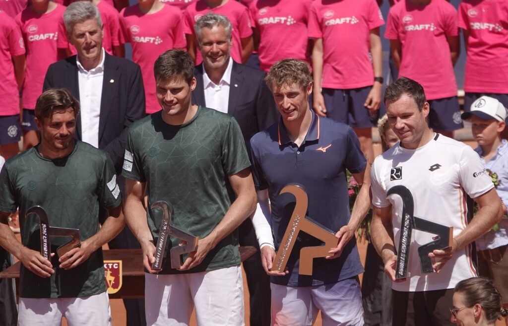 Doubles finalists holding their chamois trophies at the 2026 Kitzbuhel Open