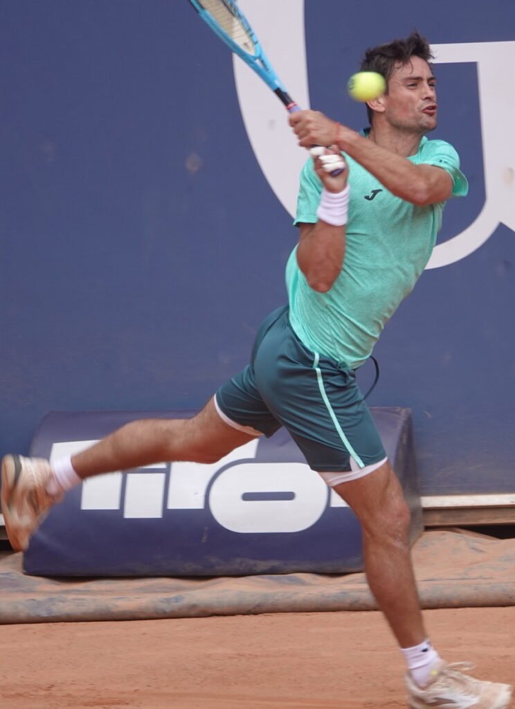 Argentine tennis player Mariano Navone hitting a backhand during his quarterfinal match in Kitzbuhel on clay