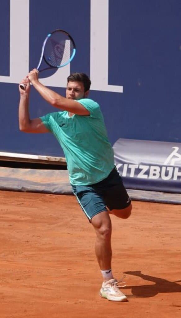 Serbian tennis player Miomir Kecmanovic hitting a forehand during his first-round match on clay