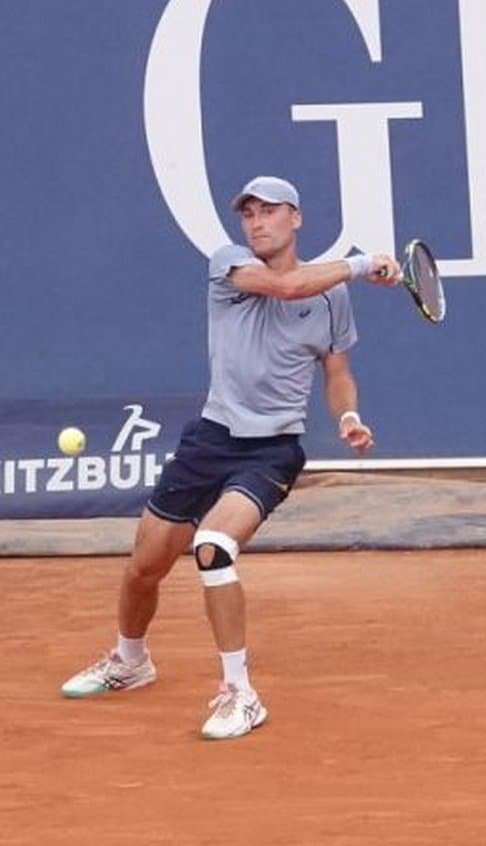 Belgian tennis player Raphael Collignon hitting a forehand during his match in Kitzbuhel on clay