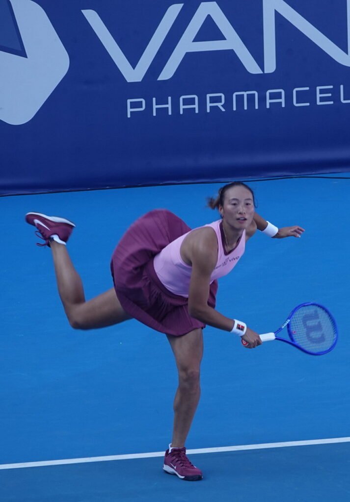 Chinese tennis player Zheng Qinwen in mid-air hitting a serve during the Athens Open 26 tournament