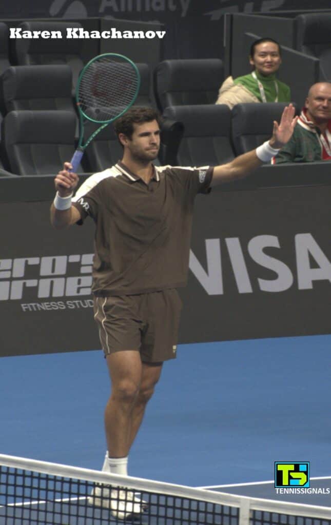 Karen Khachanov raising his hand to greet the crowd after his victory over Rei Sakamoto at the Almaty tournament.