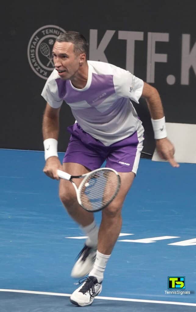 Kazakhstani tennis player Mikhail Kukushkin hitting a forehand during an exhibition match at the Almaty arena.