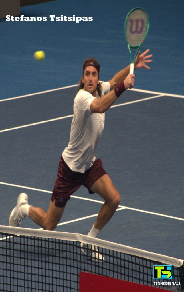 Stefanos Tsitsipas hitting a volley at the net during his first-round match against Aleksandar Kovacevic in Almaty.